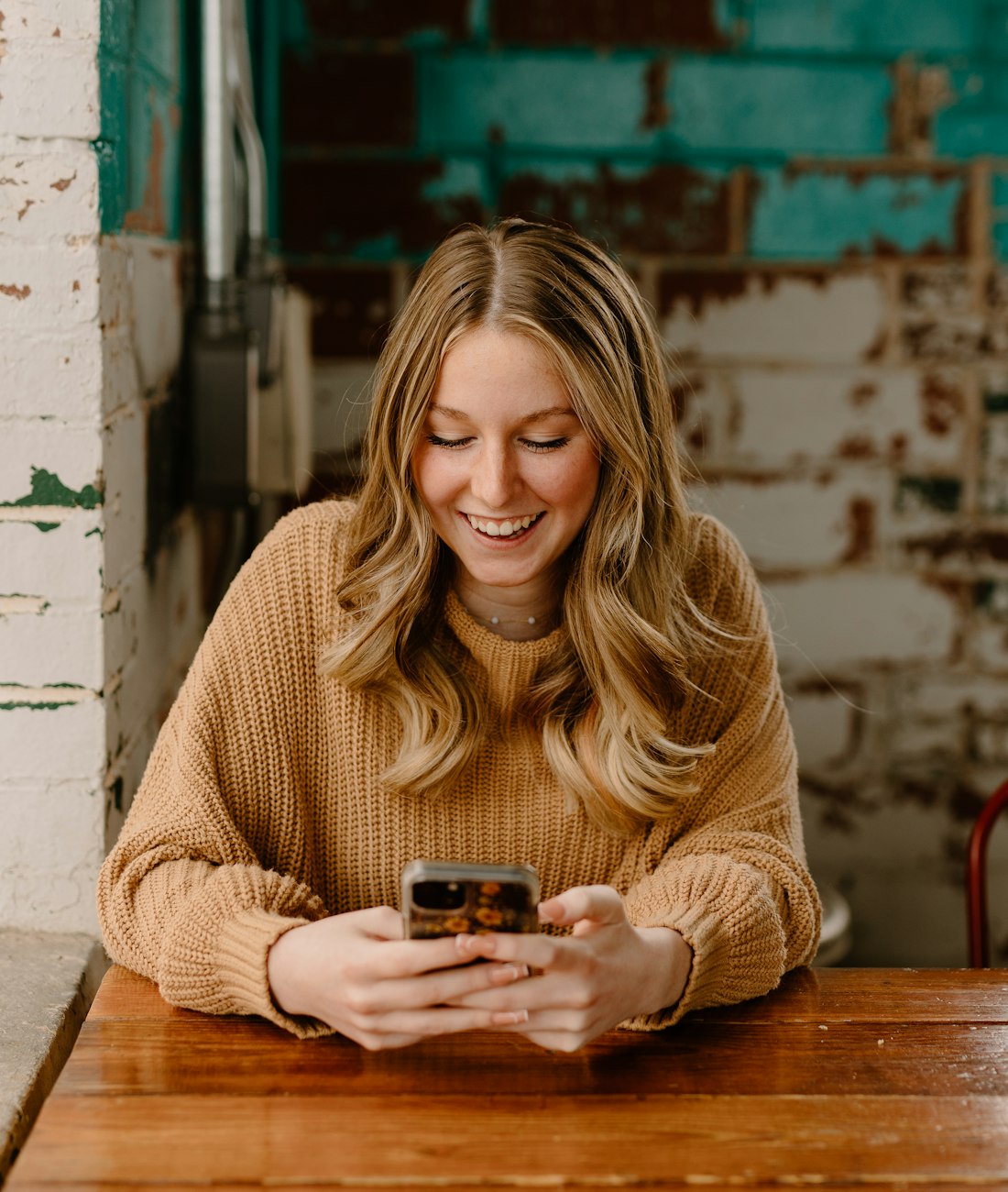 A member smiling while using the ZenX app on their phone